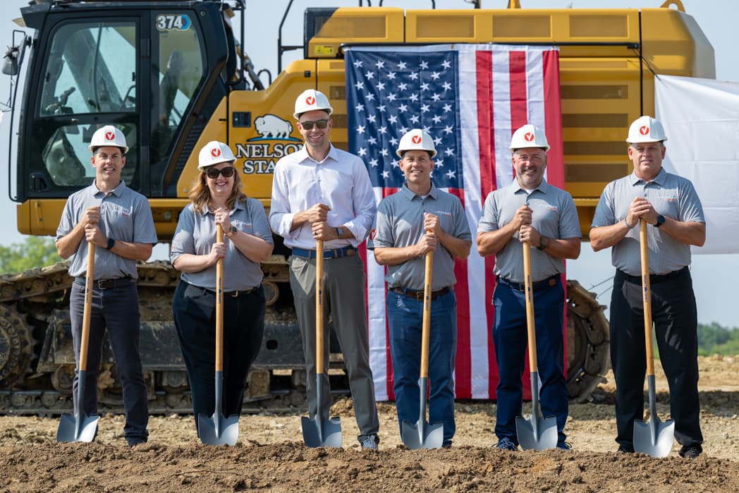 Six executives in hard hats with shovels posing at construction groundbreaking ceremony with American flag — Cincinnati event photographer K Dalton