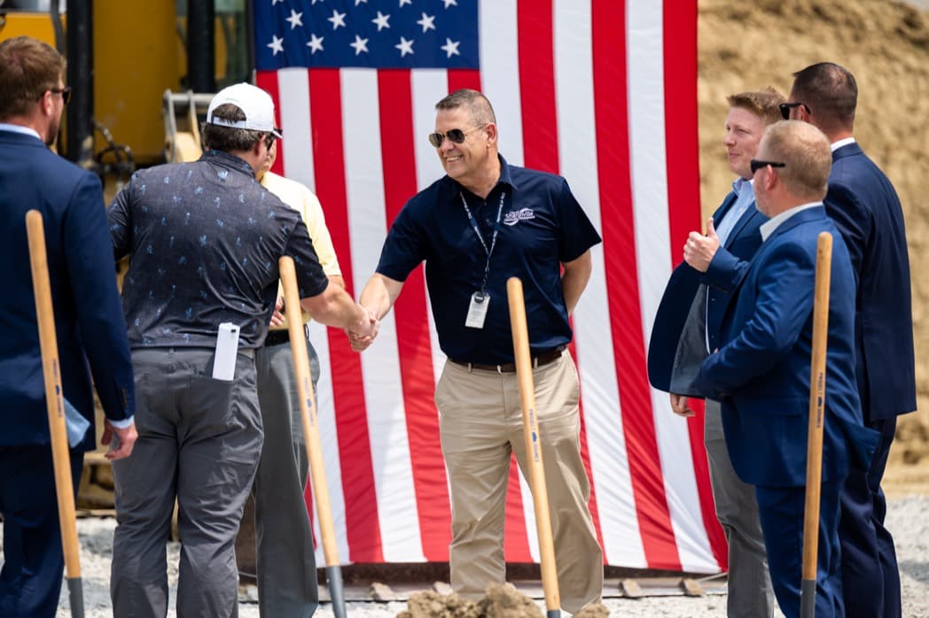 Business executives shaking hands at groundbreaking ceremony with American flag backdrop — Cincinnati event photographer K Dalton