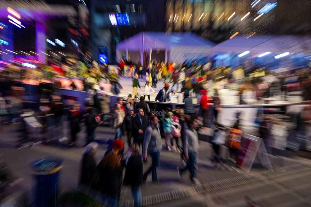 Motion blur of crowd at downtown nighttime event with purple lighting — Cincinnati event photographer K Dalton