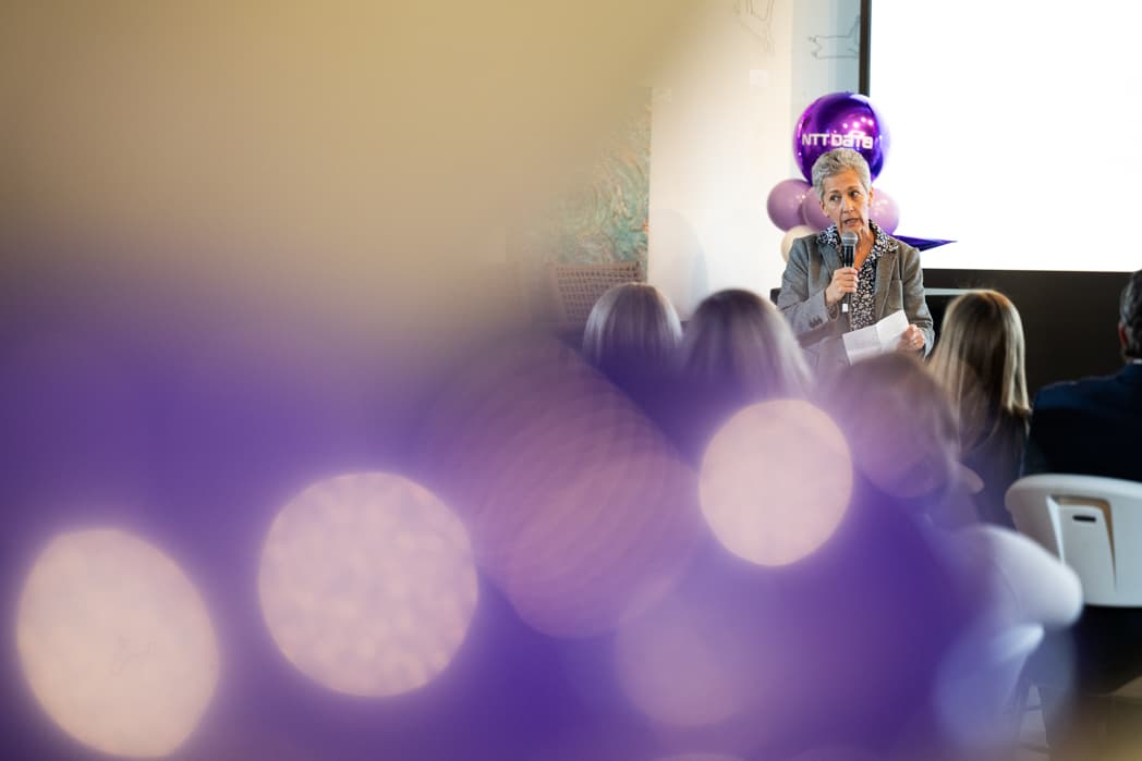 Speaker addressing audience through bokeh foreground at NTT Data corporate event — Cincinnati event photographer K Dalton